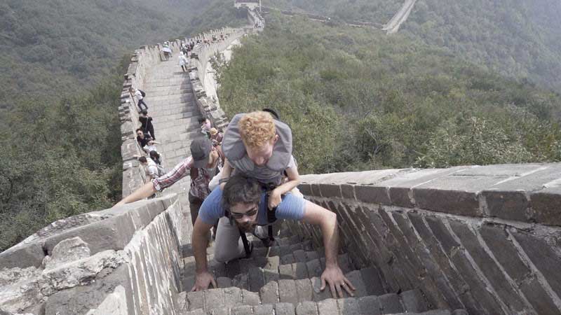 Kevan being carried along the Great Wall of China