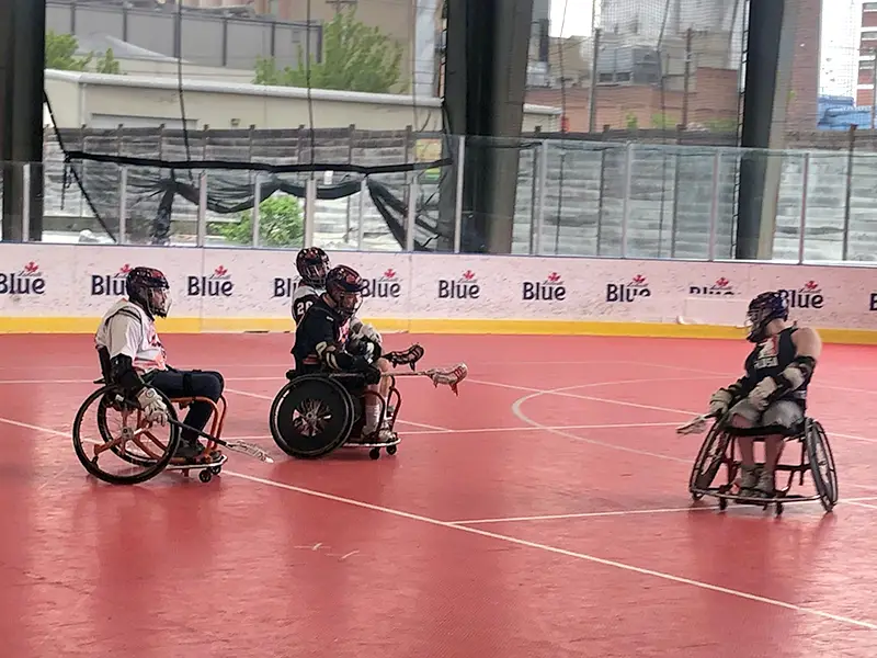 Wheelchair lacrosse players mid-game